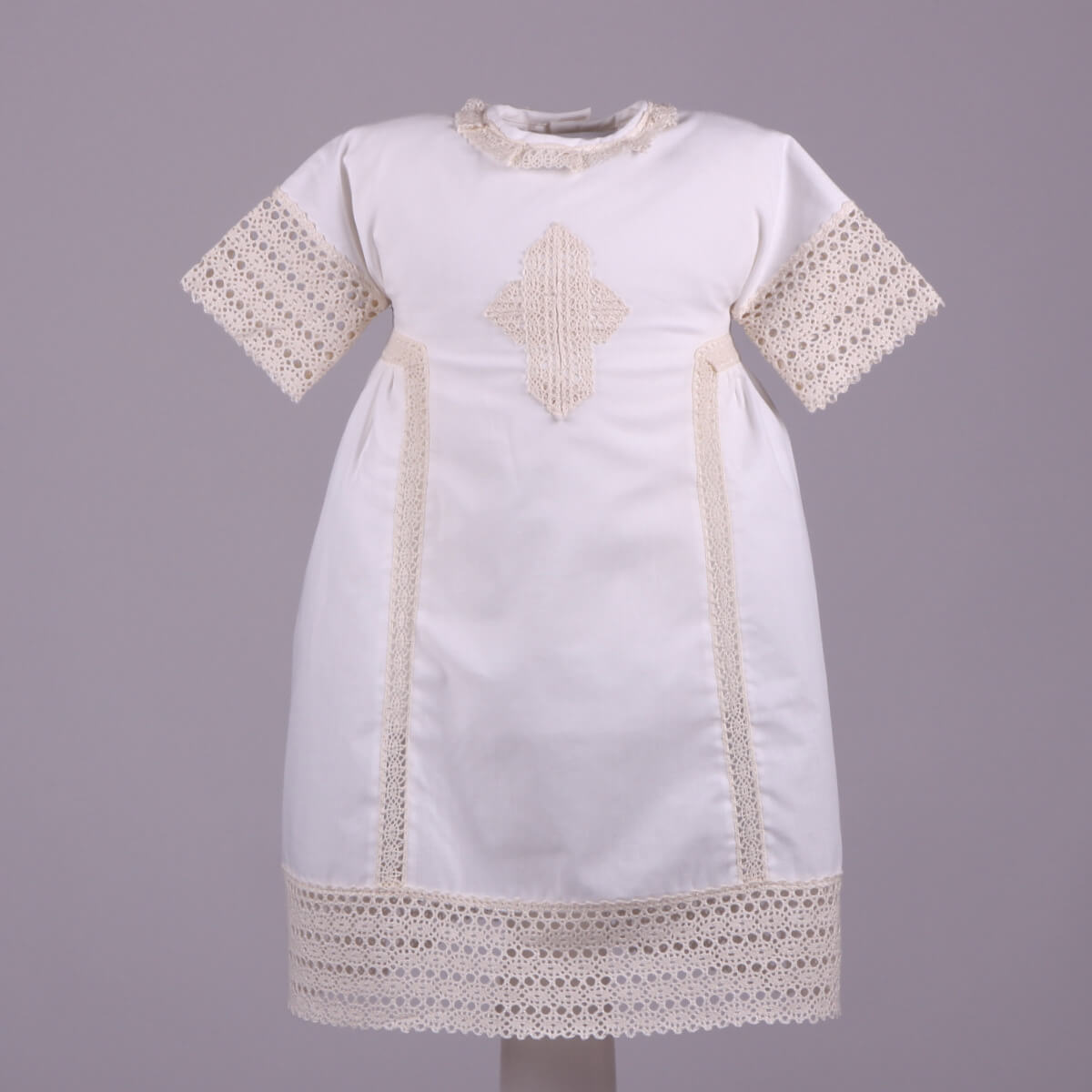Baptism Gown with lace details on a gray background