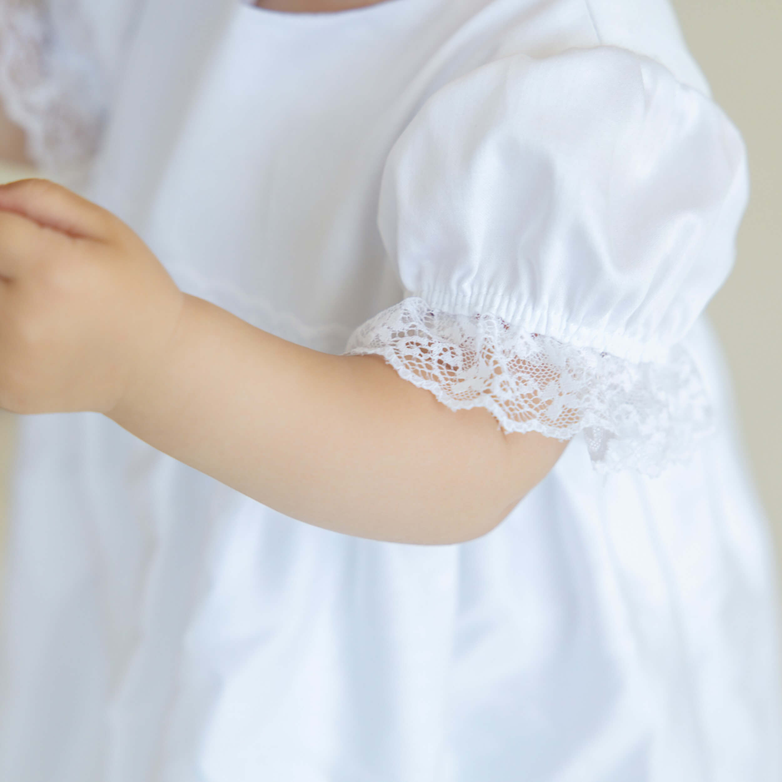 Baptism Dress with Lace on a plain background