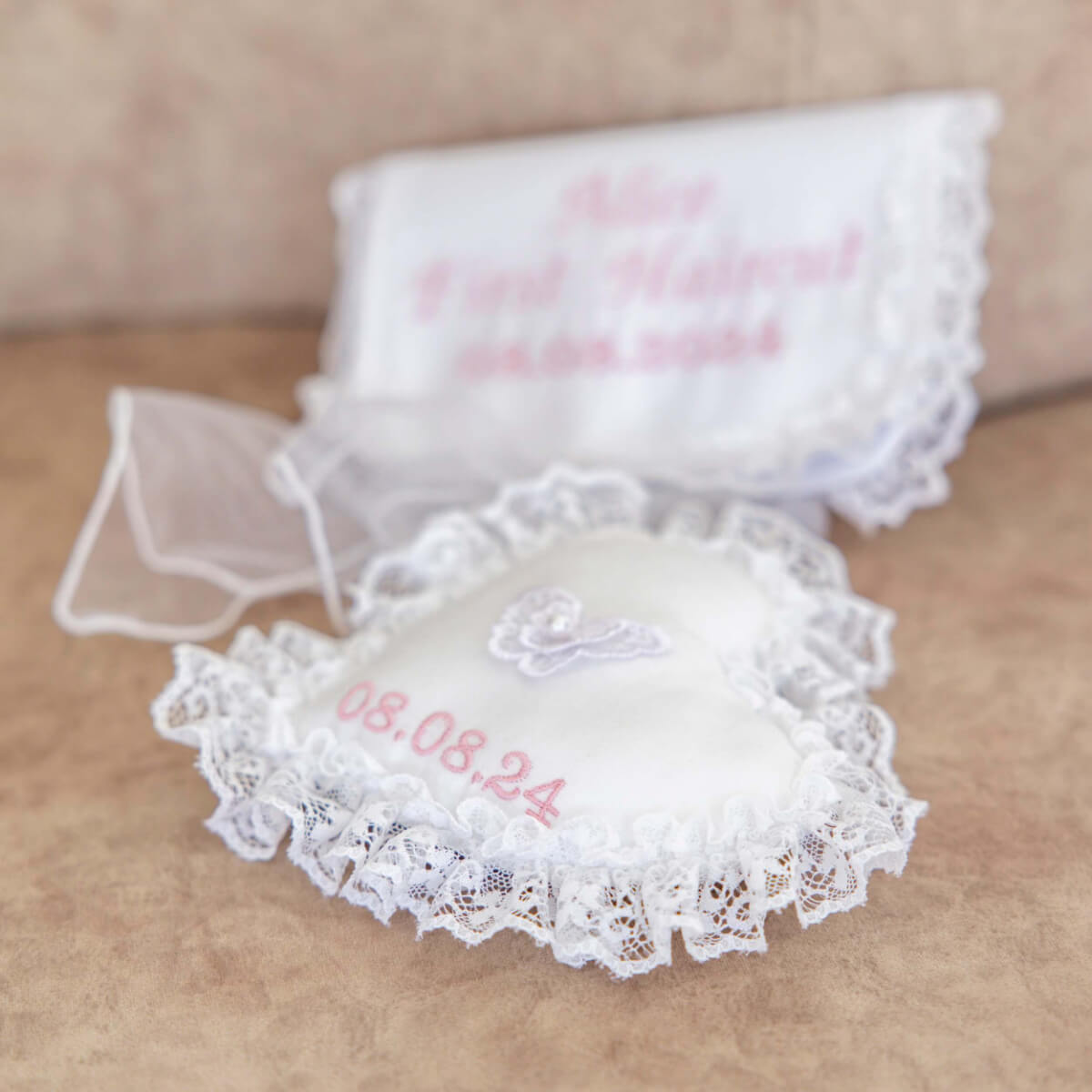  Baptism Ring Pillow  with personalized embroidery on a beige surface