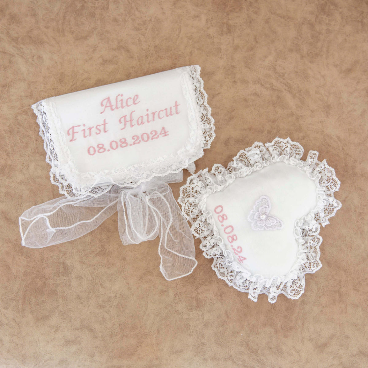 First Curl Keepsake Box with embroidered text on a beige background