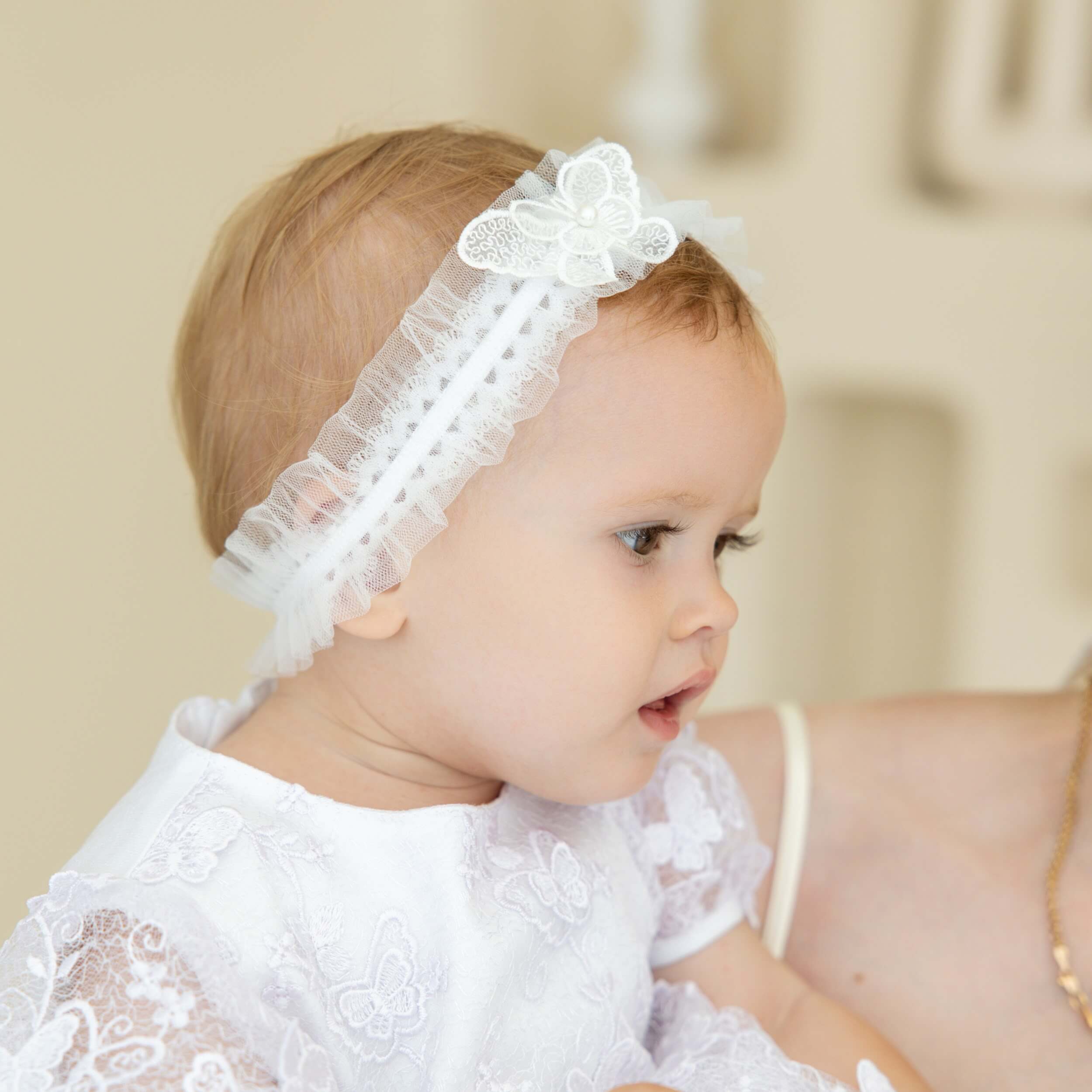 Girl wearing  baby headband with a blurred background