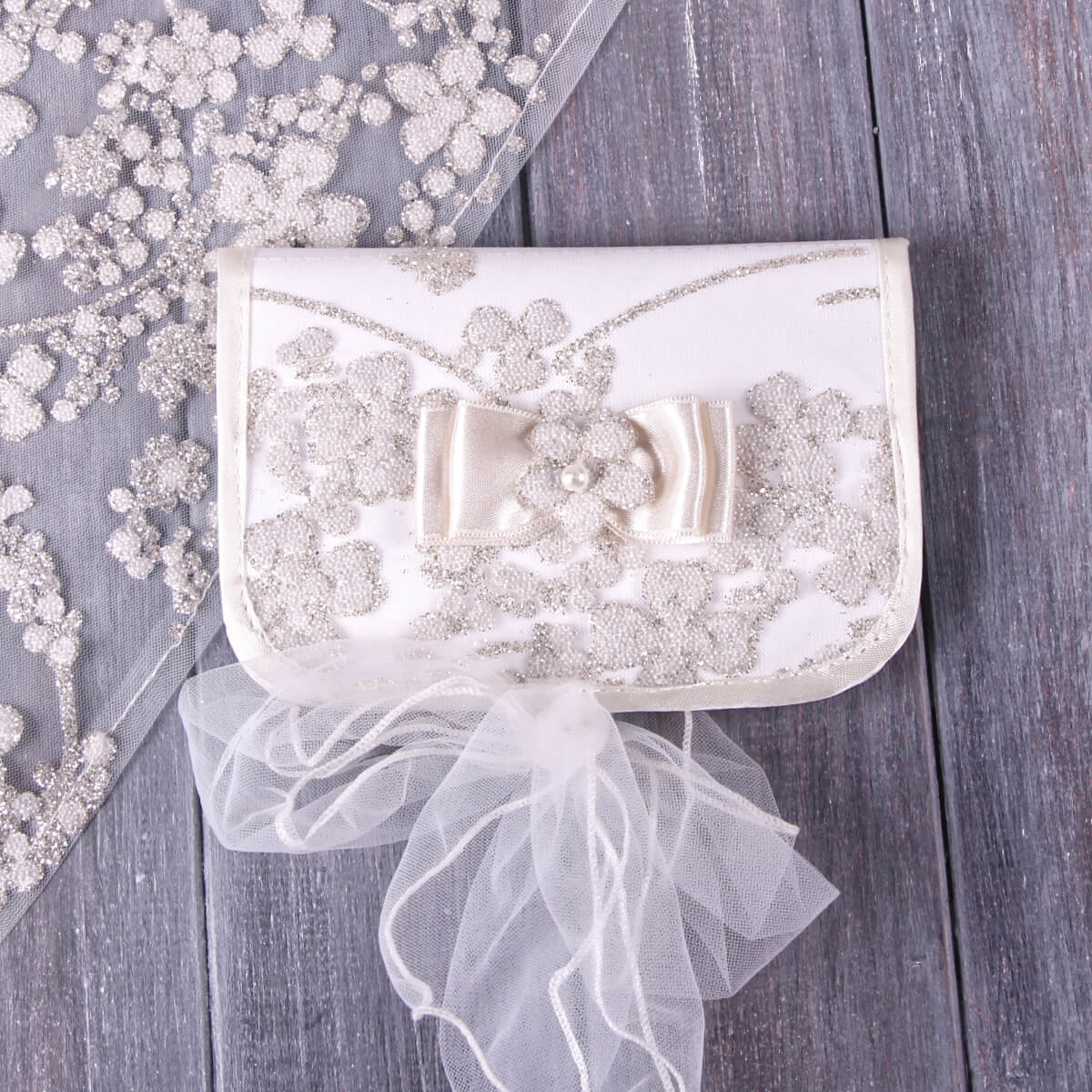 Baby Baptism Keepsake Box with floral embellishments and a bow on a wooden surface
