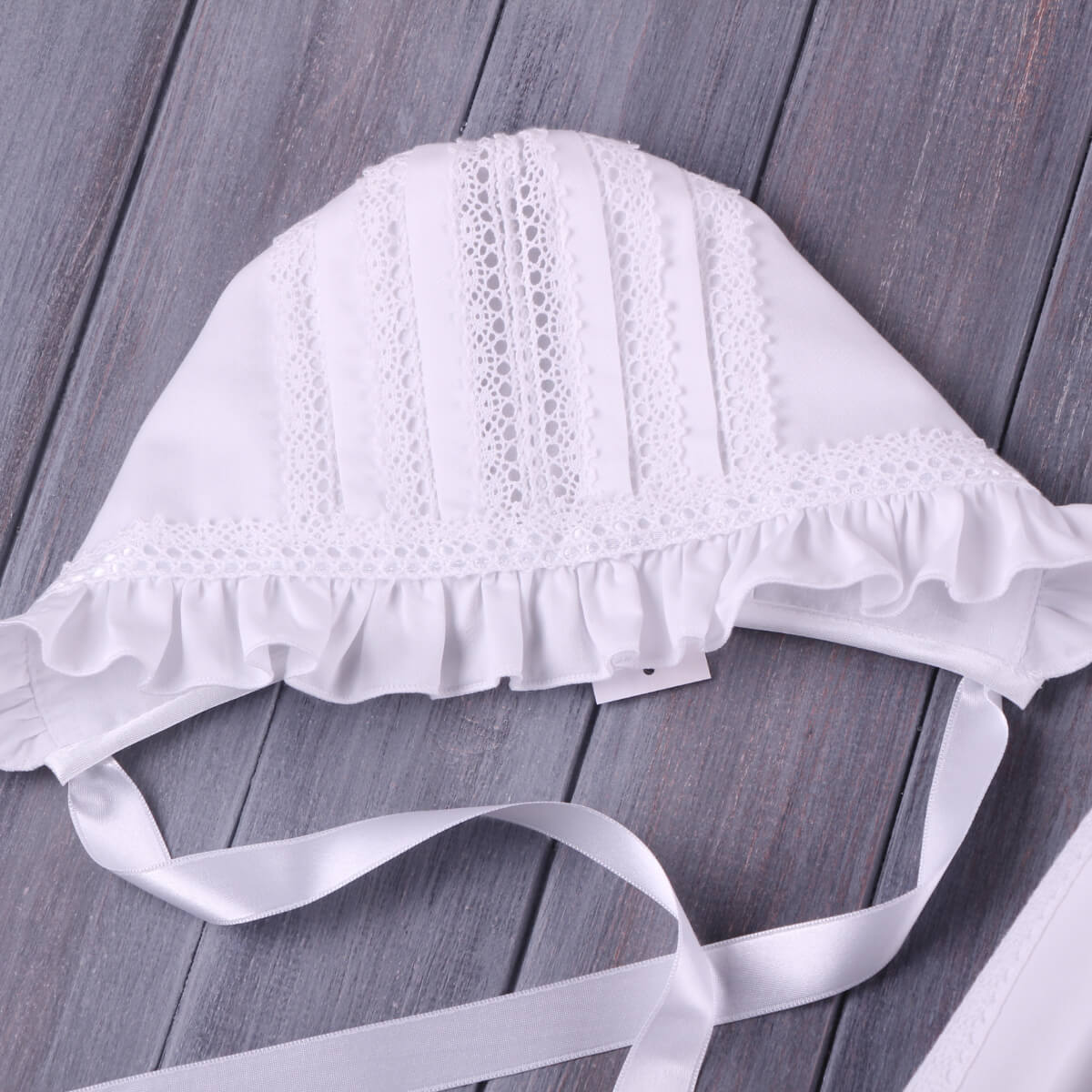 Lace Baptism Bonnet on a wooden surface