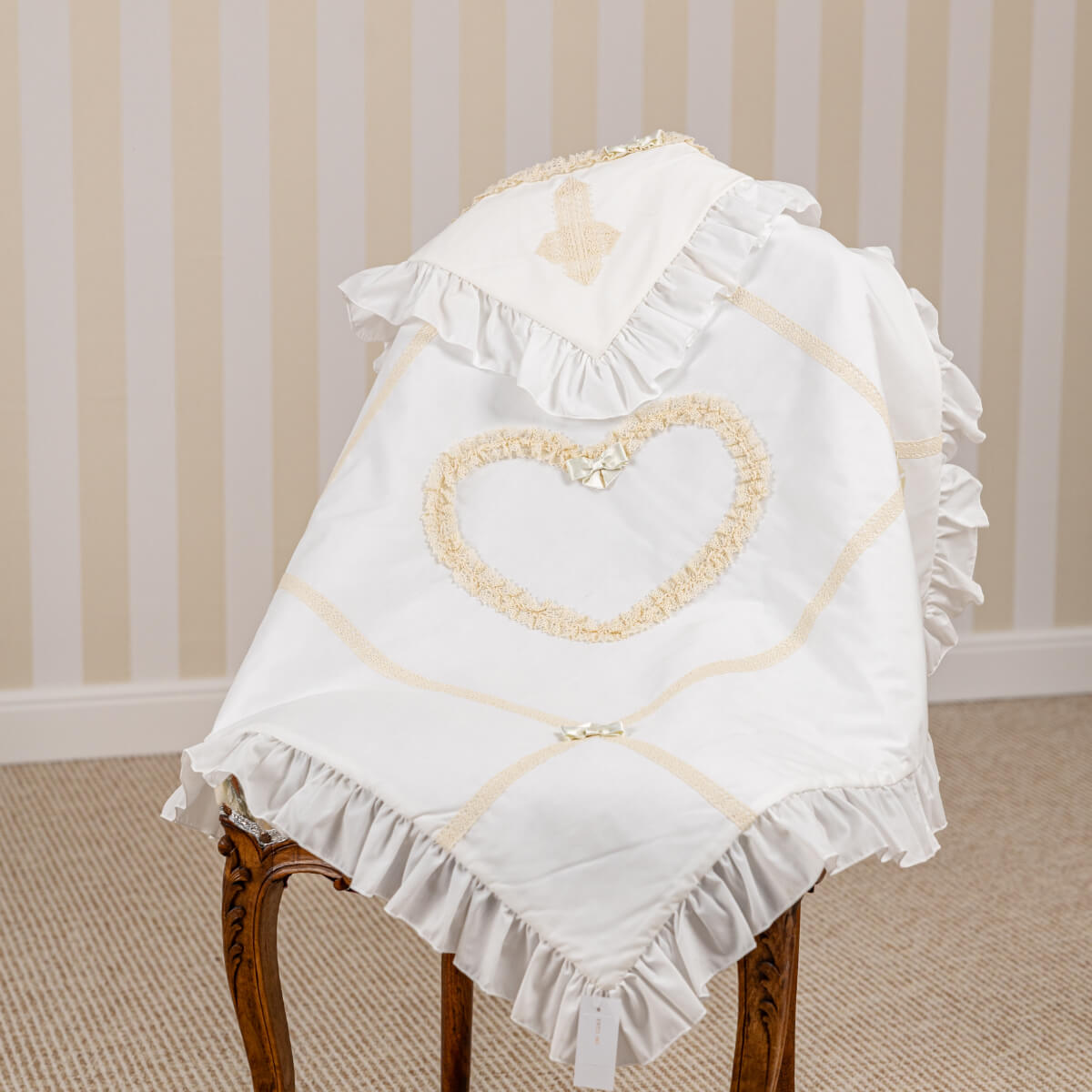 White baptism blanket with ruffles and a heart design 