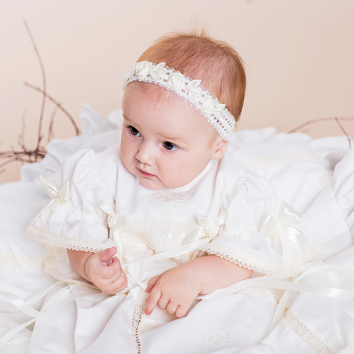 Heirloom Christening Dress with lace details on a soft beige background